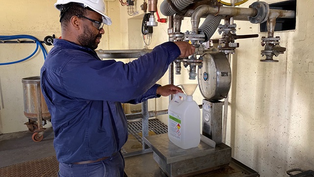 United Initiators employee at chemical factory location in Banksmeadow, Australia.
