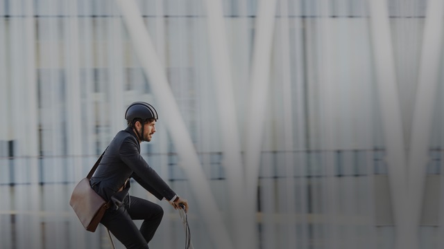 Man promotes sustainability by riding a bike.